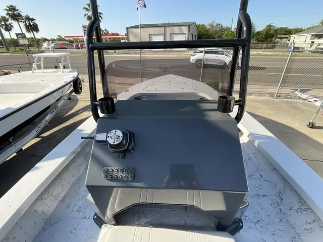 Slide: The Image of 2025 Majek 22 XTREME boat console with steering wheel and controls, parked outdoors. - 14