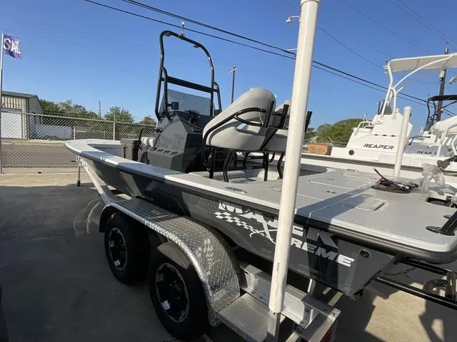 Slide: The Image of 2025 Majek 22 XTREME boat on trailer, parked outdoors, showcasing sleek design and modern features. - 3