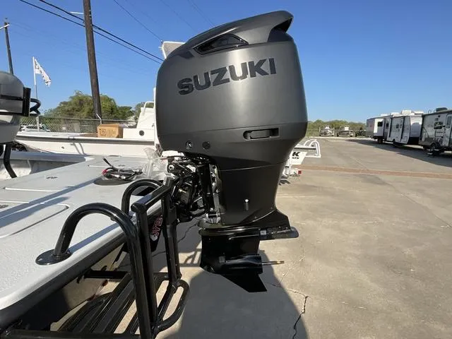 Slide: The Image of 2025 Majek 22 XTREME boat with Suzuki outboard motor in a parking lot. - 4