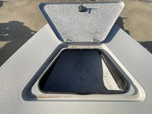 Slide: The Image of Open hatch on 2025 Majek 22 XTREME boat deck, showcasing interior access. - 8