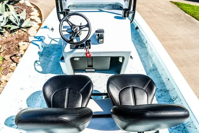 Slide: The Image of 2025 Majek 2206 Illusion boat interior with black seats and steering wheel. - 10