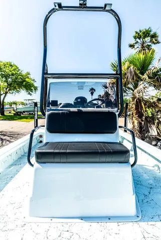 Slide: The Image of 2025 Majek 2206 Illusion boat with sleek seating and console, surrounded by palm trees. - 14