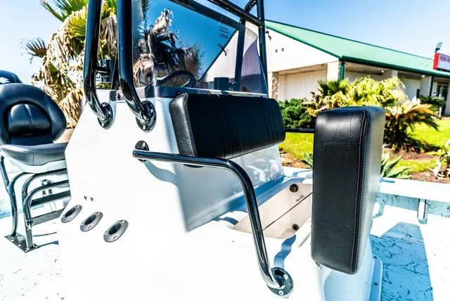 Slide: The Image of 2025 Majek 2206 Illusion boat interior with black seating and console, outdoors. - 15