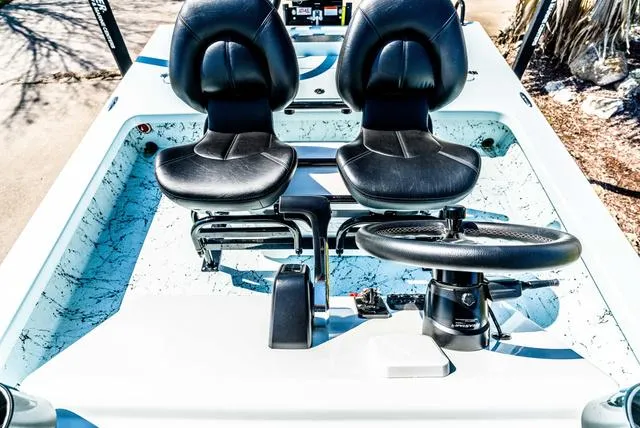 Slide: The Image of 2025 Majek 2206 Illusion boat interior with dual black seats and steering wheel. - 18
