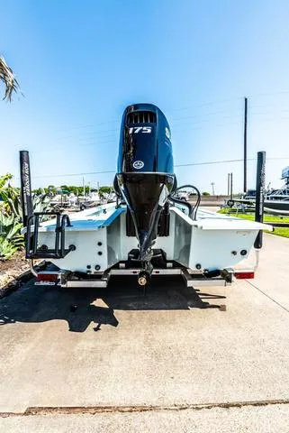 Slide: The Image of 2025 Majek 2206 Illusion boat with powerful outboard motor, parked on a sunny day. - 5