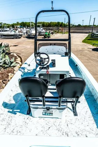 Slide: The Image of 2025 Majek 2206 Illusion boat with dual seats and steering console, parked outdoors. - 6