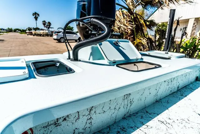 Slide: The Image of 2025 Majek 2206 Illusion boat deck with storage compartments and motor, sunny day. - 8