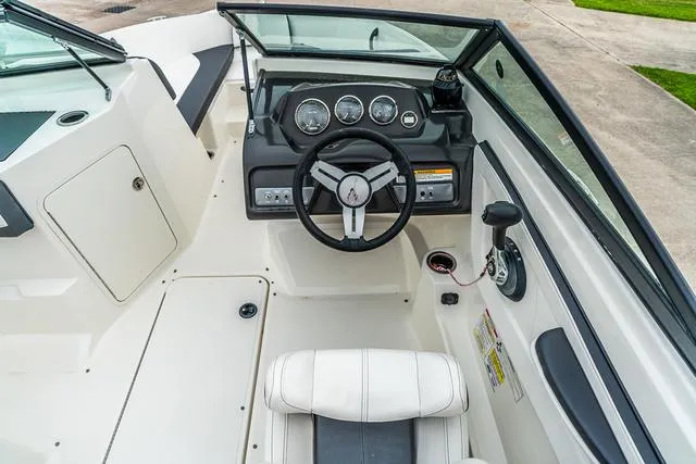 Slide: The Image of 2015 Sea Ray 19spx ob boat cockpit with steering wheel and dashboard controls. - 10