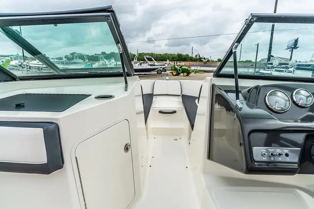 Slide: The Image of 2015 Sea Ray 19spx ob boat interior with open windshield and dashboard view. - 12