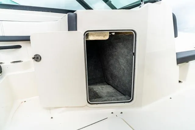 Slide: The Image of Open storage compartment on a 2015 Sea Ray 19spx ob boat. - 13