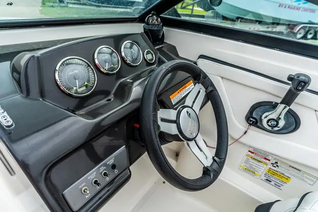 Slide: The Image of 2015 Sea Ray 19spx ob boat dashboard with steering wheel and control panel. - 14