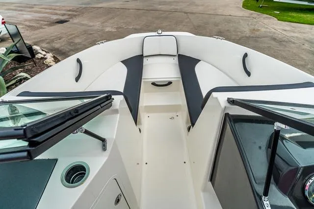 Slide: The Image of 2015 Sea Ray 19spx ob boat interior with open bow seating and windshield. - 16
