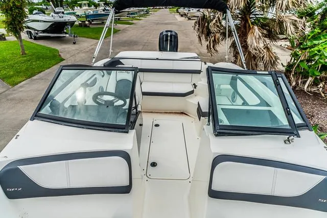 Slide: The Image of 2015 Sea Ray 19spx ob boat with open windshield, parked outdoors. - 18