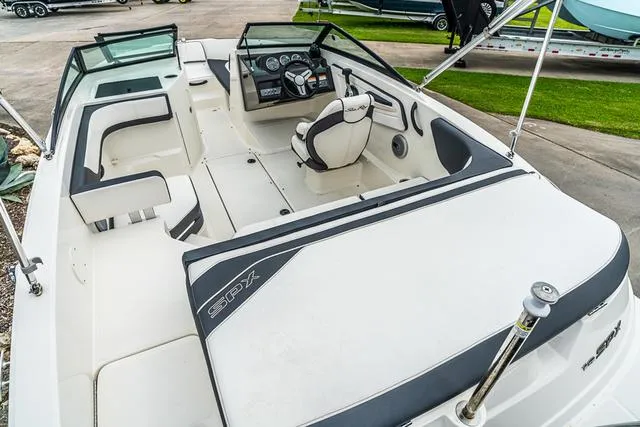 Slide: The Image of 2015 Sea Ray 19spx ob boat interior with seating and steering console. - 5