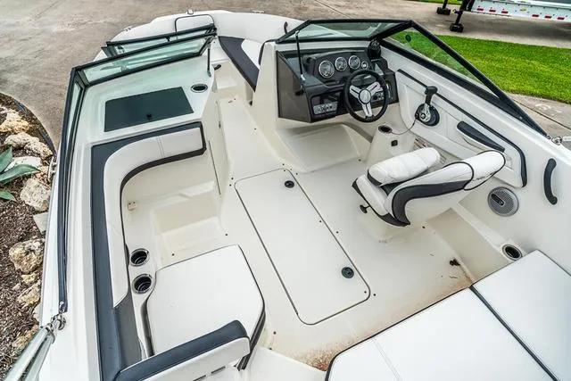 Slide: The Image of 2015 Sea Ray 19spx ob boat interior with seating, steering wheel, and dashboard. - 8