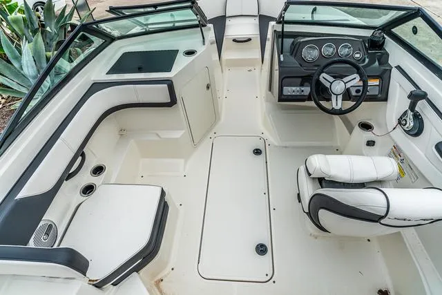 Slide: The Image of 2015 Sea Ray 19spx ob boat interior with steering wheel and seating. - 9