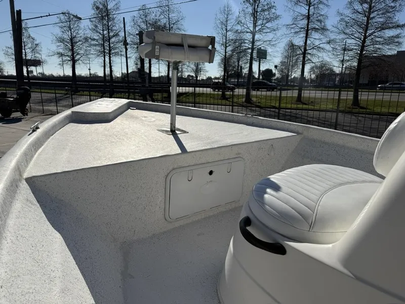 Slide: The Image of 2011 NauticStar 190R RG boat interior with white seating and storage compartment. - 2