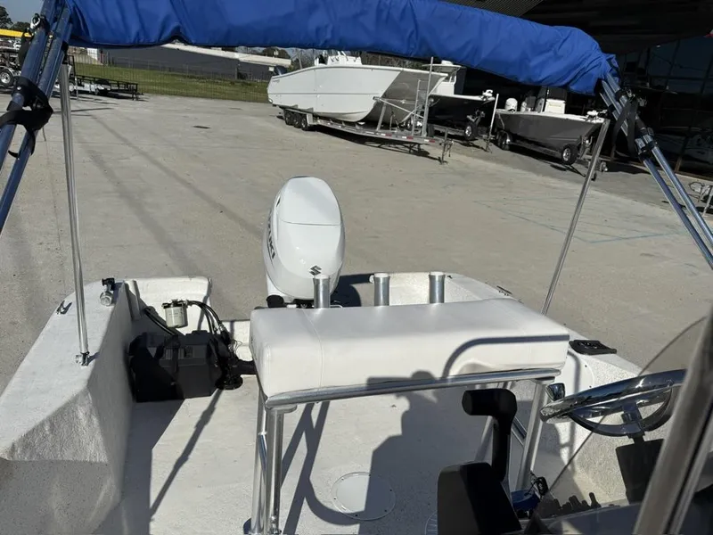 Slide: The Image of 2011 NauticStar 190R RG boat with blue canopy and Suzuki outboard motor. - 9