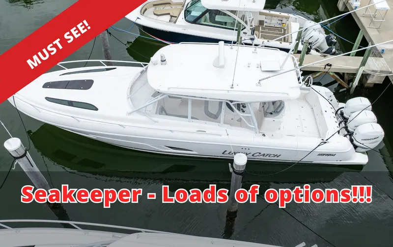 Slide: The Image of 2022 Intrepid 409 Valor boat with Seakeeper, docked, featuring multiple options. - 0