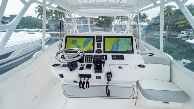 Slide: The Image of 2022 Intrepid 409 Valor boat cockpit with advanced navigation system and steering wheel. - 1