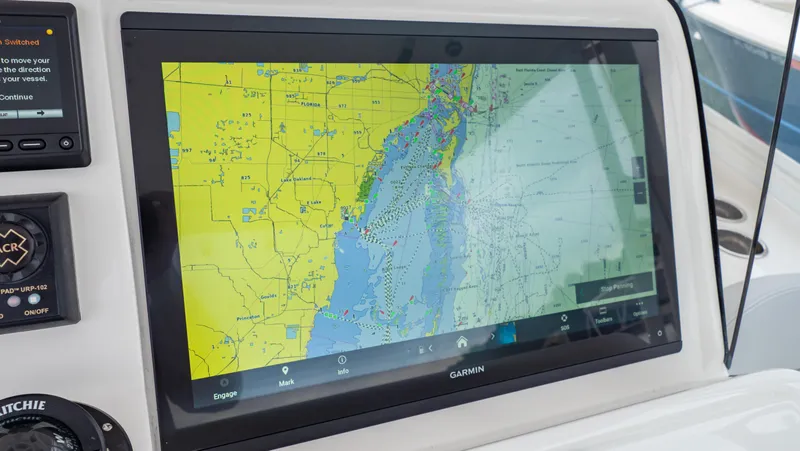 Slide: The Image of 2022 Intrepid 409 Valor boat with Garmin navigation display showing detailed marine map. - 10