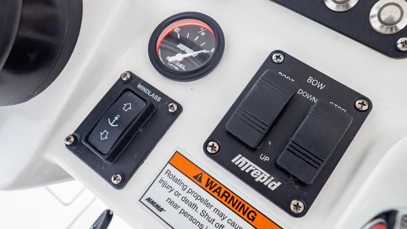 Slide: The Image of Control panel of 2022 Intrepid 409 Valor boat with switches and warning label. - 18