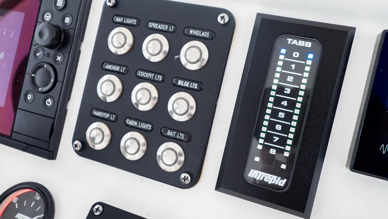 Slide: The Image of Control panel of 2022 Intrepid 409 Valor boat with labeled buttons and display. - 19