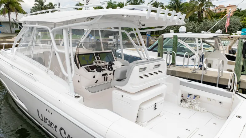 Slide: The Image of 2022 Intrepid 409 Valor boat docked, featuring a sleek white design and modern cockpit. - 22