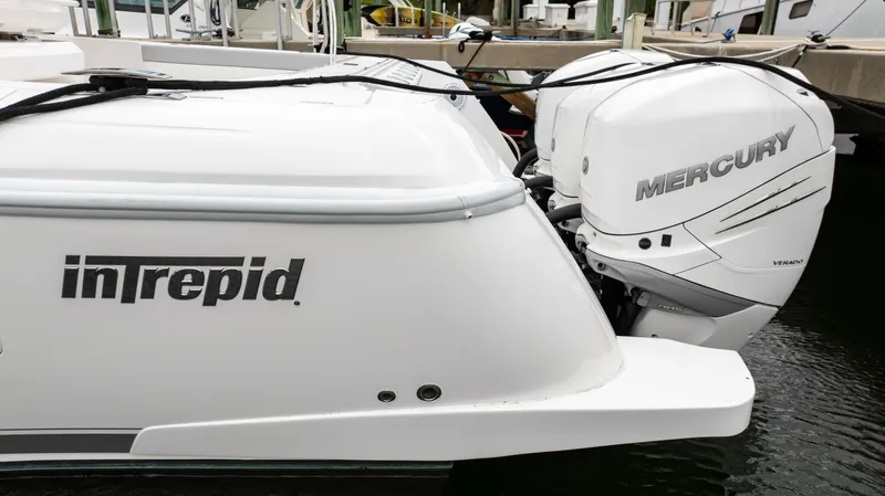 Slide: The Image of 2022 Intrepid 409 Valor boat with Mercury outboard engines docked in marina. - 24