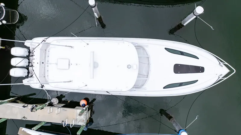 Slide: The Image of Aerial view of a 2022 Intrepid 409 Valor yacht docked at a marina. - 29