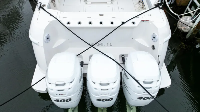 Slide: The Image of 2022 Intrepid 409 Valor boat with triple 400 horsepower engines, docked in Miami, FL. - 3