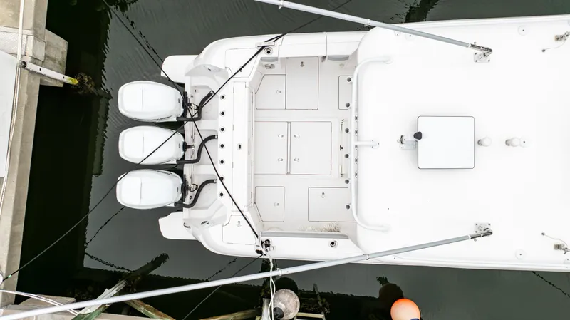 Slide: The Image of Aerial view of 2022 Intrepid 409 Valor boat docked with triple outboard engines. - 30