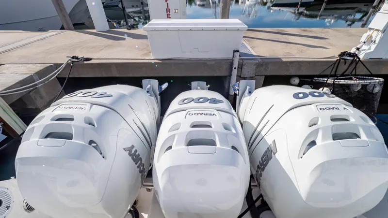 Slide: The Image of Triple outboard engines on a 2022 Intrepid 409 Valor boat at a dock. - 34