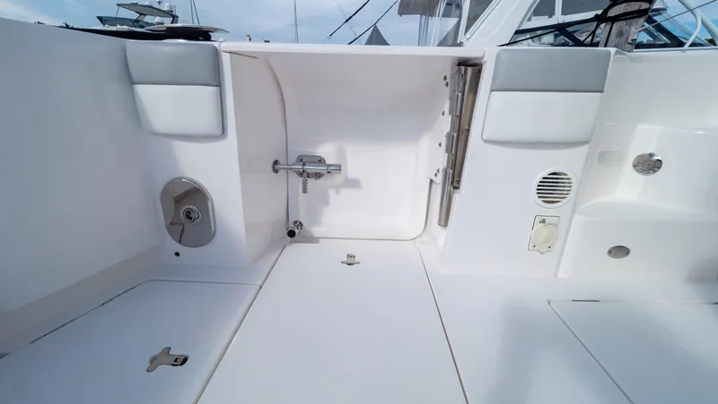 Slide: The Image of 2022 Intrepid 409 Valor boat interior, showcasing sleek white design and modern fixtures. - 42