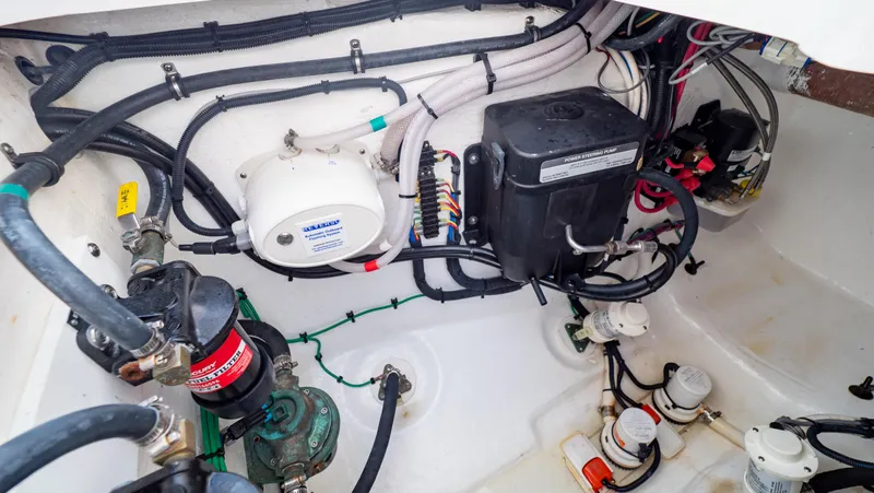 Slide: The Image of Engine compartment of 2022 Intrepid 409 Valor boat, showcasing wiring and mechanical components. - 46