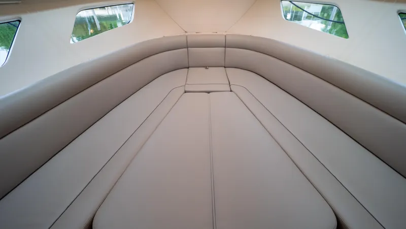 Slide: The Image of Interior view of 2022 Intrepid 409 Valor boat cabin with beige seating. - 7