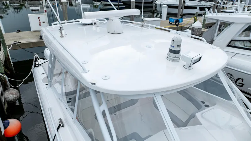 Slide: The Image of 2022 Intrepid 409 Valor boat docked at marina, showcasing sleek white design. - 8