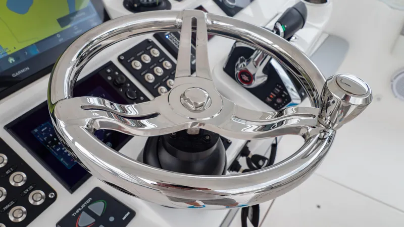 Slide: The Image of Steering wheel of 2022 Intrepid 409 Valor boat with control panel and navigation system. - 9