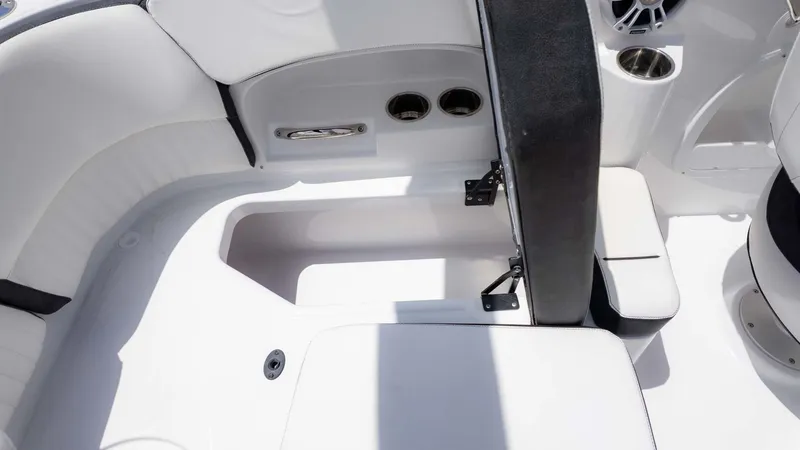 Slide: The Image of Interior of 2025 Stingray 211DC boat, featuring white seating and storage compartments. - 10