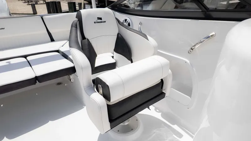 Slide: The Image of 2025 Stingray 211DC boat interior with luxurious white and black seating. - 12