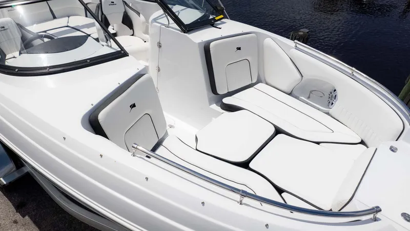 Slide: The Image of 2025 Stingray 211DC boat interior with white seating and sleek design. - 5