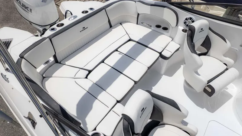 Slide: The Image of 2025 Stingray 211DC boat interior with white seating and modern design. - 6