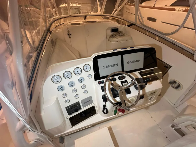 Slide: The Image of 2005 Intrepid 377 Walkaround boat cockpit with Garmin navigation displays and control panel. - 4