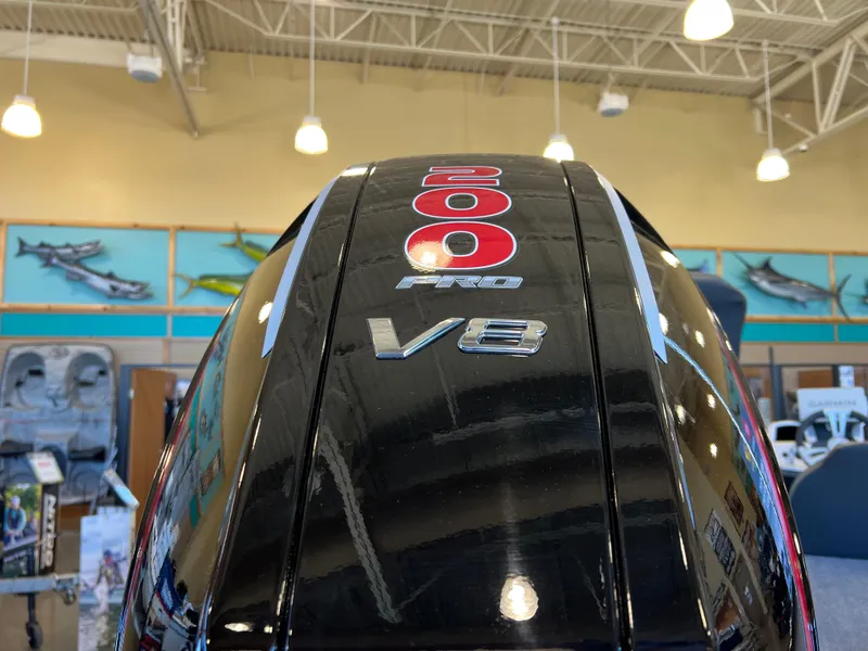 Slide: The Image of 2025 Tracker Savage 215 V8 engine with 200 horsepower, displayed indoors. - 8