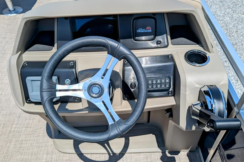 Slide: The Image of 2025 Sun Tracker Fishin' Barge 20 DLX steering console with modern controls and cup holder. - 5