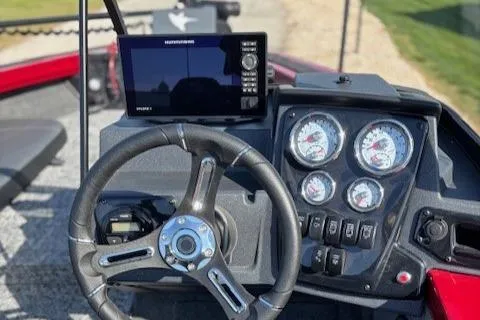 Slide: The Image of 2025 Tracker Targa V-19 Combo dashboard with steering wheel and gauges. - 2
