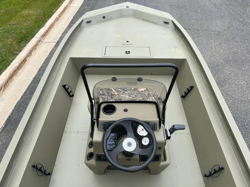 Slide: The Image of 2025 Tracker Grizzly 1860 CC boat interior with steering console and gauges. - 3