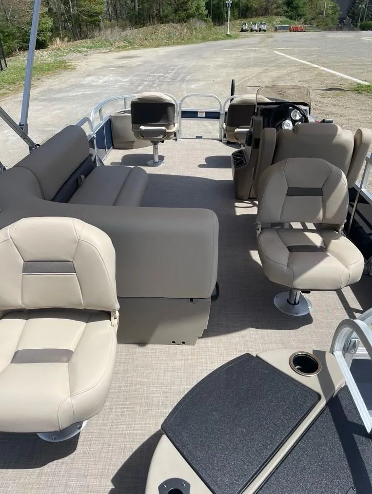 Slide: The Image of 2025 Sun Tracker Bass Buggy 18 DLX pontoon boat interior with beige seating. - 4
