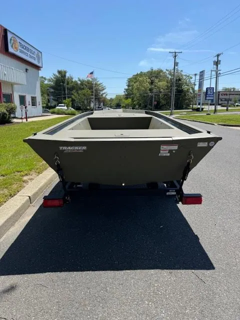 Slide: The Image of 2025 Tracker Grizzly 1648 Jon boat on trailer, parked on a sunny street. - 2