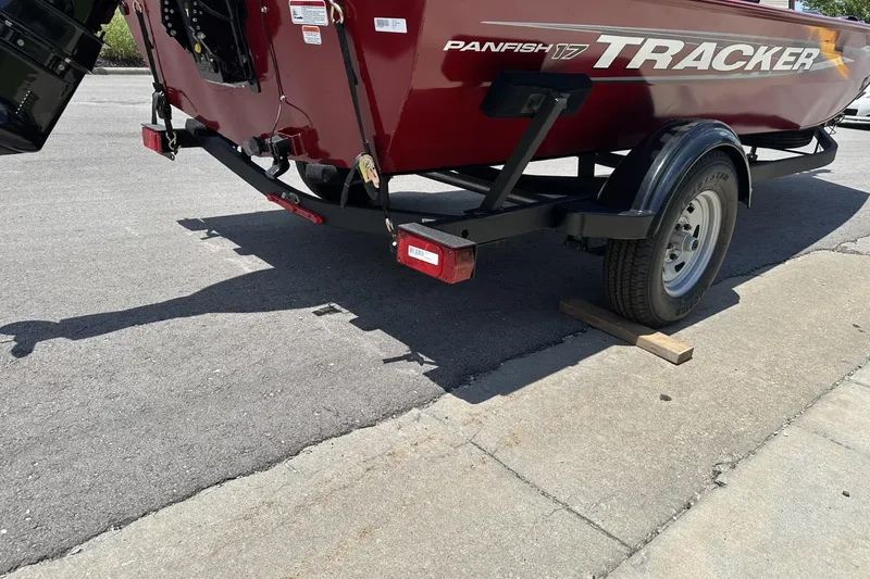Slide: The Image of 2025 Tracker Panfish 17 boat on trailer, parked on pavement. - 3
